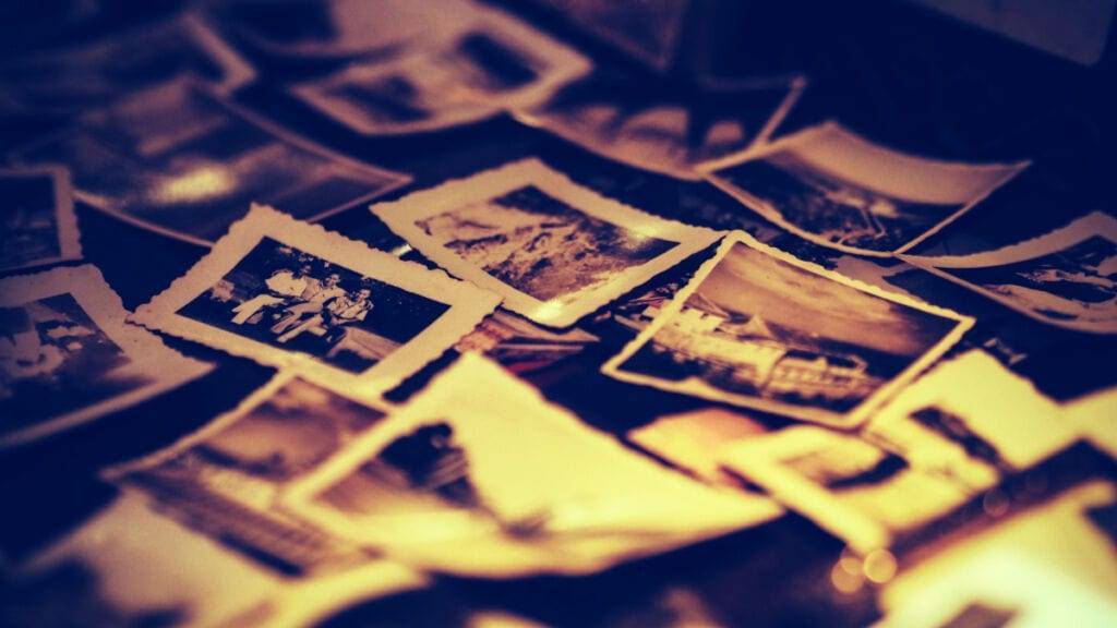 A pile of old photos, serving as a time capsule, displays unforgettable moments and offers unique insights into the past.