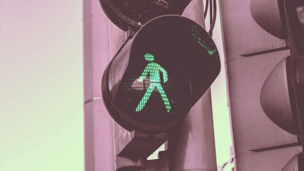 A green traffic light with a person on it, providing unforgettable insights on brain science.